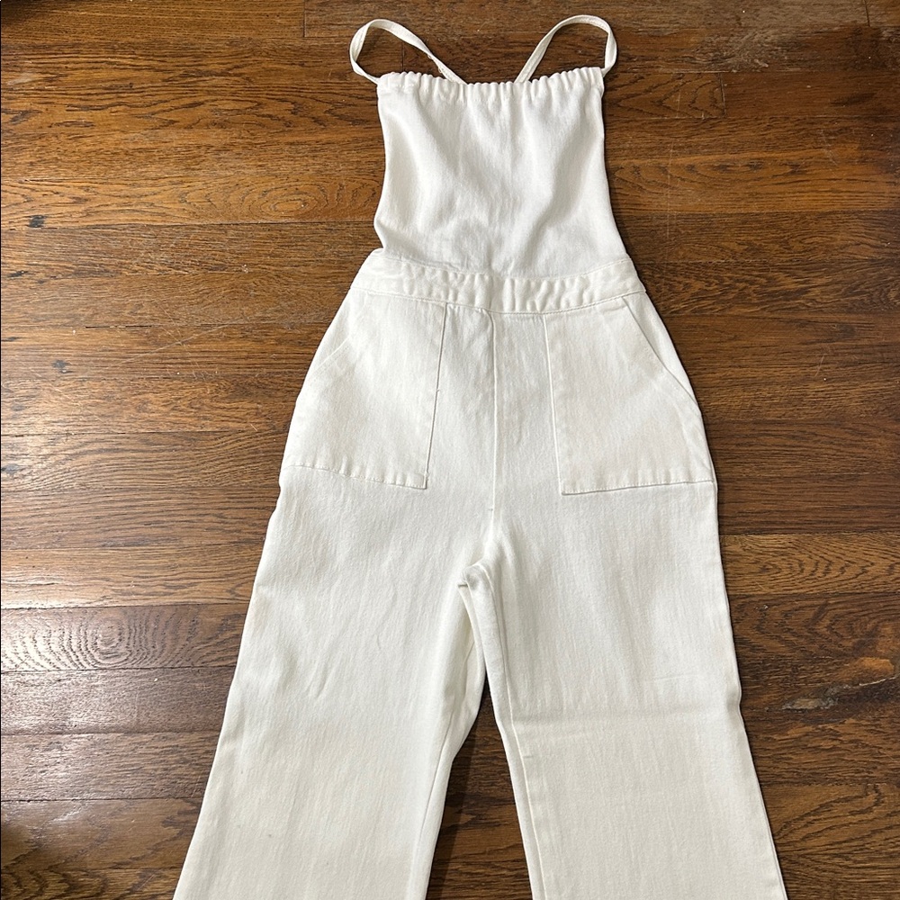 Blue blush white denim jumpsuit with lace up back and flare legs.